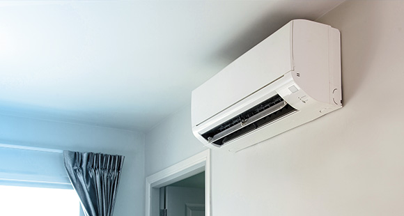 a wall mounted air conditioning unit blowing cool air into a room