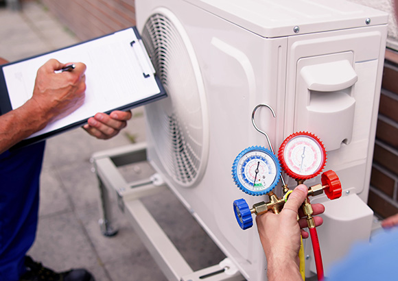 two technicians perform diagnostics for an industrial air conditioning repair