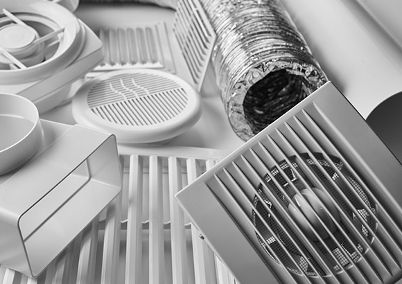 the components of a ventilation system sitting on a white floor